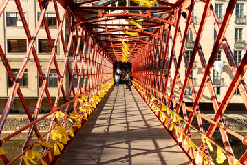 Girona's iconic red bridge, the Pont de les Peixateries Velles, adds a bold and striking element to...