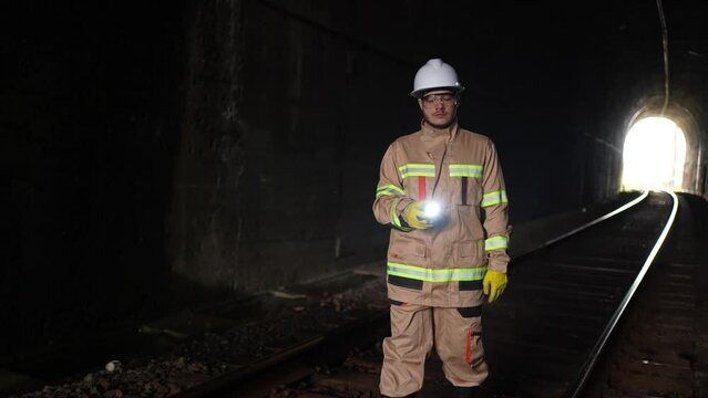 tunnel inspection a railway engineer with a lantern in his hands goes through the tunnel checks slow mo