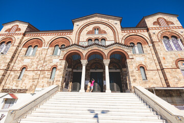 Hagia Triada neo-byzantine Cathedral facade exterior in Piraeus, Holy Trinity Greek Orthodox church, Piraeus city street view, Attica, Greece, summer sunny day with a blue sky