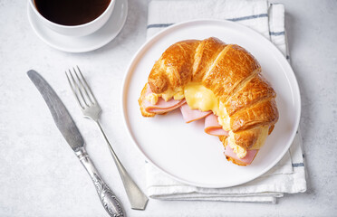 Ham cheese scrambled eggs croissant for breakfast