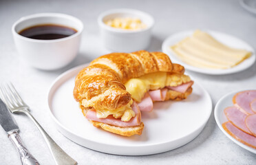 Ham cheese scrambled eggs croissant for breakfast