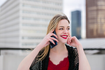 Happy woman calling on phone on a coffee shop