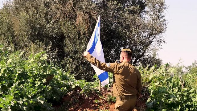 Israel Defense Forces Soldier Kissing the Israeli Flag Twice and salutes Flag of Israel. Themes slow motion video: Israeli soldier, IDF, Israeli Army, soldiers uniform, Independence Day Israel