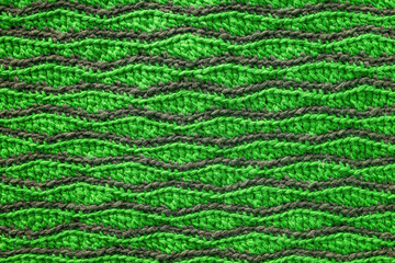 Green grey crocheted wave pattern. Knitted texture.