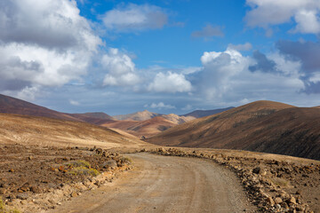 Fototapeta na wymiar Gravel road in the mountains in the west of the island of Fuerteventura