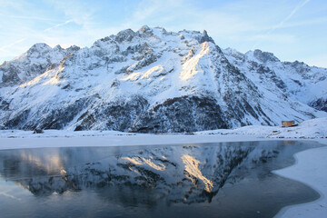 The beautiful Pontet Lake in the french Alps with view on La Meije mountain