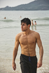 Handsome young man standing on a beach in Phuket Island, Thailand