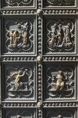 antique golden bas relief on entrance to Florence basilica 