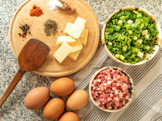ingredients for preparing omelet with bacon cheese and fresh vegetables