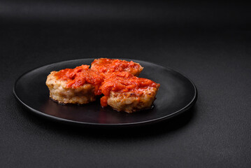 Delicious fresh cutlets or meatballs with spices, herbs and tomato sauce