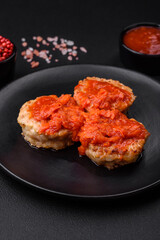 Delicious fresh cutlets or meatballs with spices, herbs and tomato sauce