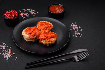 Delicious fresh cutlets or meatballs with spices, herbs and tomato sauce