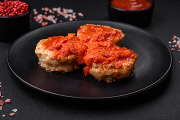 Delicious fresh cutlets or meatballs with spices, herbs and tomato sauce