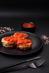 Delicious fresh cutlets or meatballs with spices, herbs and tomato sauce
