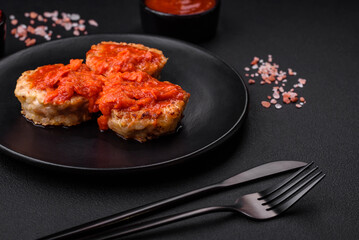 Delicious fresh cutlets or meatballs with spices, herbs and tomato sauce