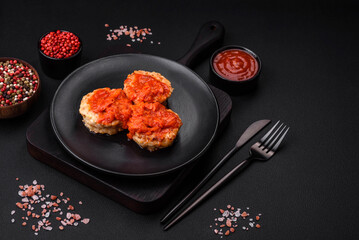 Delicious fresh cutlets or meatballs with spices, herbs and tomato sauce
