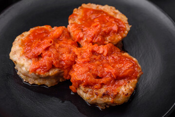 Delicious fresh cutlets or meatballs with spices, herbs and tomato sauce