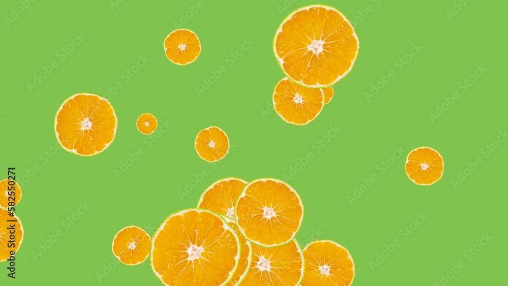 Poster abstract explosion with tangerine slices flying in different directions on a green background. creat