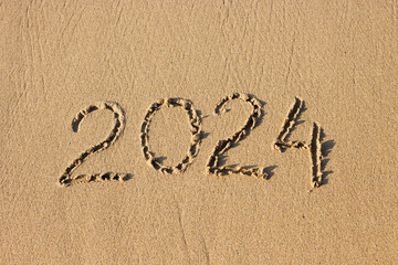 2024 number on a sand beach. Abstract background photo of coming New Year 2024