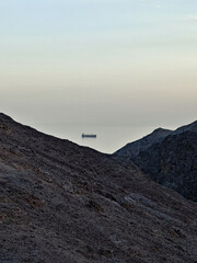 ship at sea through the mountains
