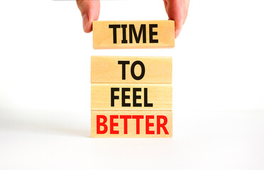 Time to feel better symbol. Concept words Time to feel better on wooden block. Beautiful white table white background. Businessman hand. Motivational business time to feel better concept. Copy space