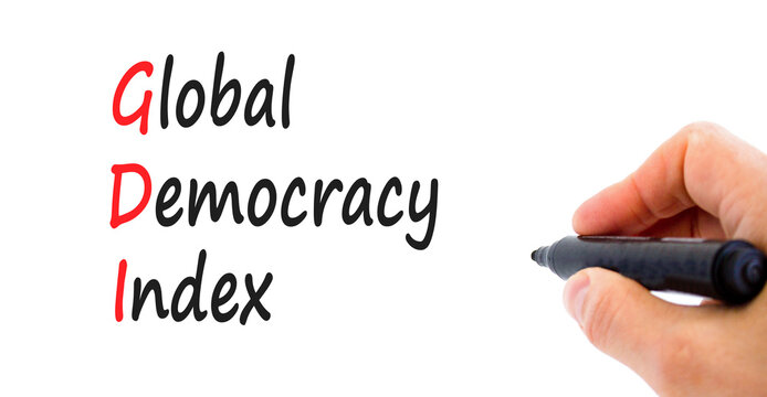 GDI global democracy index symbol. Concept words GDI global democracy index on paper on a beautiful white background. Businessman hand. Business and GDI global democracy index concept. Copy space