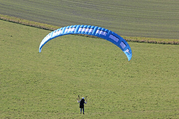Paraglider flying from a hill