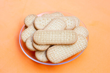 Biscuits on orange background.
