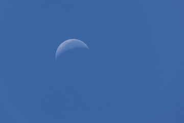 Moon waning phase on the blue sky. Nature is stunning.