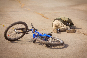 Child fell off the bike. Bicycle accident. Bicycle injury. Road safety and children