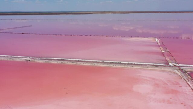 Above pink salt lake with microalgae Dunaliella salina. Famous for its antioxidant properties, enriching water by beta-carotene, used in medicine, dermatology and spa. Salt production facilities pond.