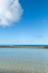 Empty Beach and Sky with a White Cumulus Cloud.
