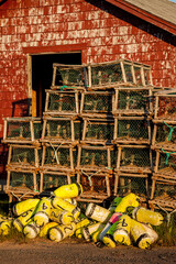 Wooden lobster traps in front of fisherman's sheds in North Lake, Prince Edward Island, Canada.