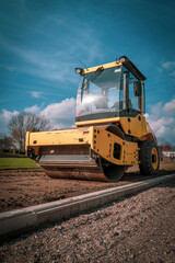 a bulldozer stands on a sports field