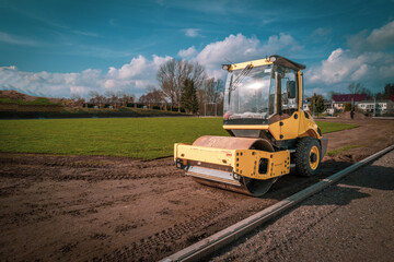 a bulldozer stands on a sports field