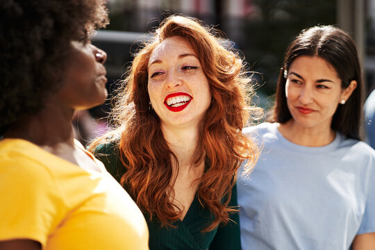 A Group Of Female Friends Chatting And Laughing Outdoors