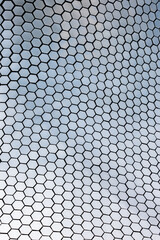 Hexagonal textured surface of building exterior.