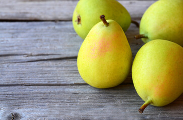 Fresh ripe organic pears on old wooden background.Pear fruits on a rustic table.Healthy eating,diet,raw food and nutrition or harvest concept.
Selective focus.