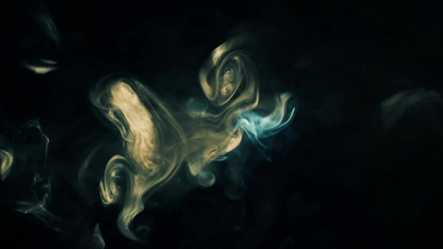 Abstract colored smoke from cigarettes on black background, video close up
