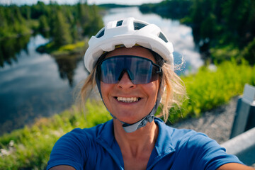 Fototapeta na wymiar cyclist takes a selfie in a helmet and sunglasses