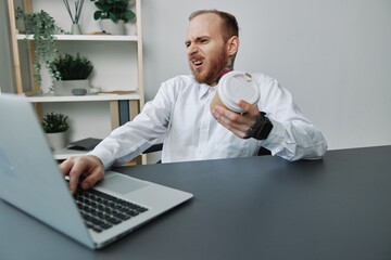 A man in a wheelchair, a businessman with tattoos in the office at a laptop, a coffee break,...