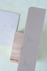 cardboard stripe with small puncture holes on a neutral background