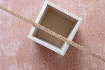 Fototapeta premium empty wood box viewed from above with decorative molding stick on paper