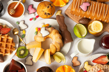 Chocolate eggs and easter almonds on bird nest, chocolate bunny and sweets on white