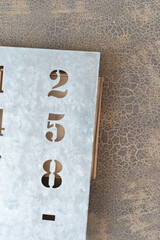 galvanized sheet metal stencil with focus on the numbers 258