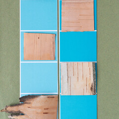 Fototapeta na wymiar birch bark squares on blue paper stripes