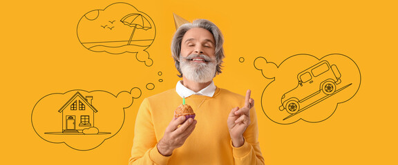 Happy mature man with birthday cake making wish on yellow background