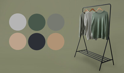 Rack with knitted sweaters on green background. Different color patterns