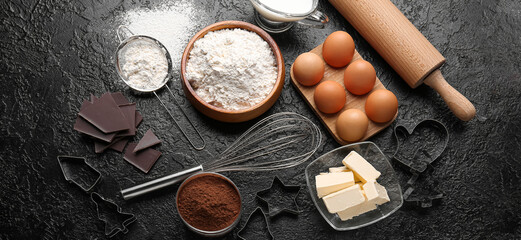 Fresh ingredients for preparing Christmas cookies on black background
