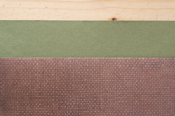 Fototapeta premium folded scrapbook paper with pattern and rough green paper on wood plank